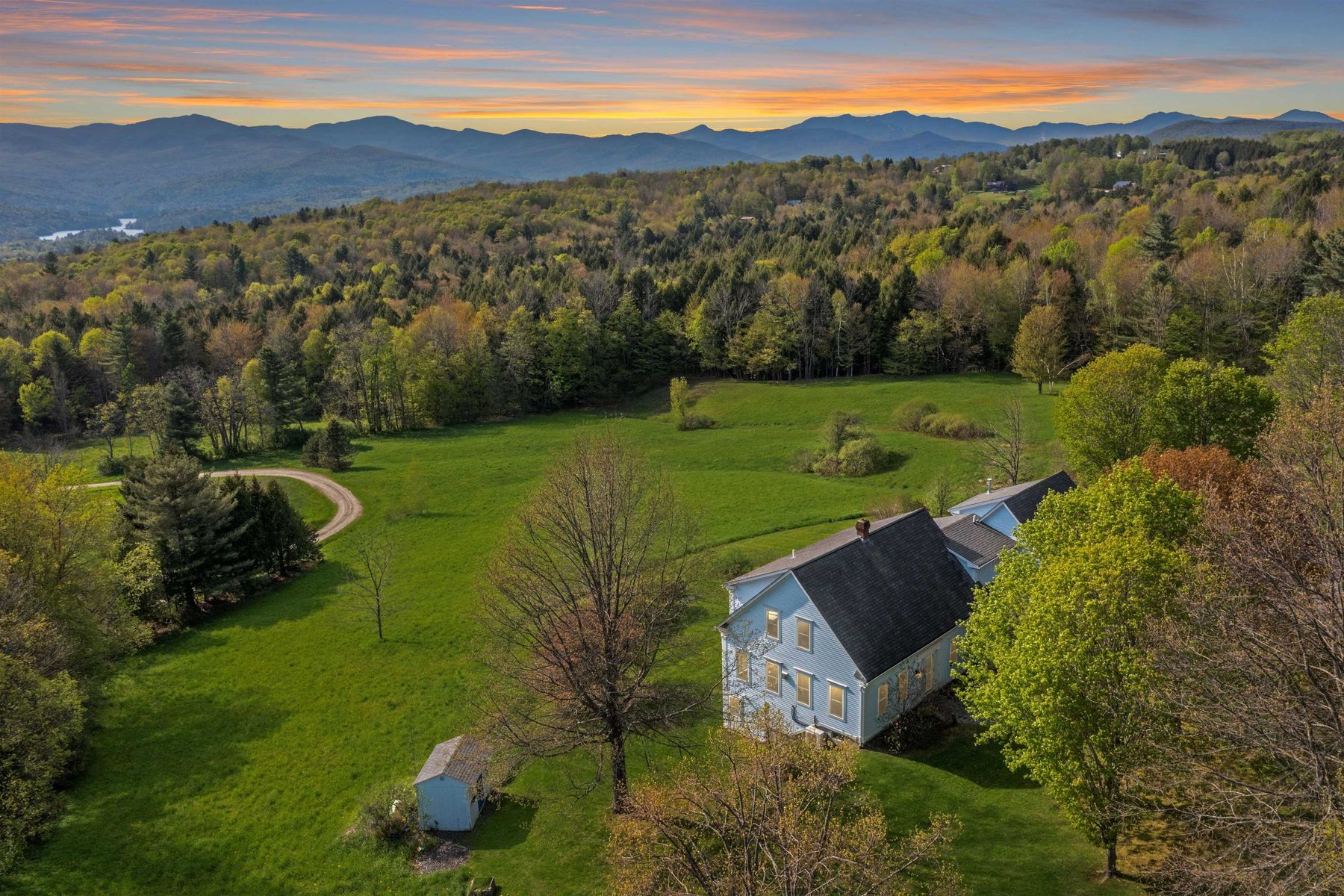 Rolling Vermont farmland below the mountains at a Waterbury property Pall has listed